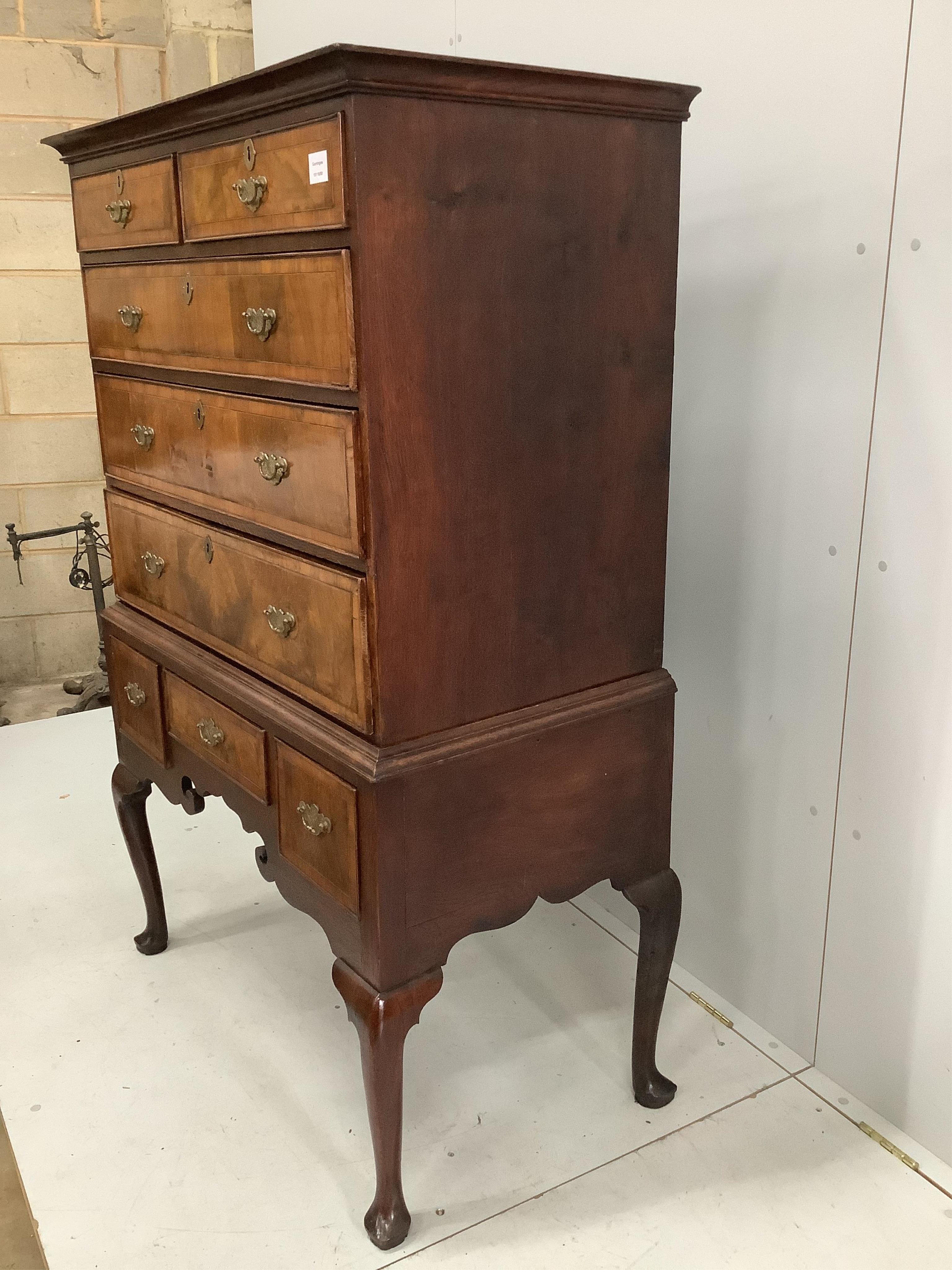 An 18th century banded walnut chest on stand, width 97cm, depth 53cm, height 152cm. Condition - fair